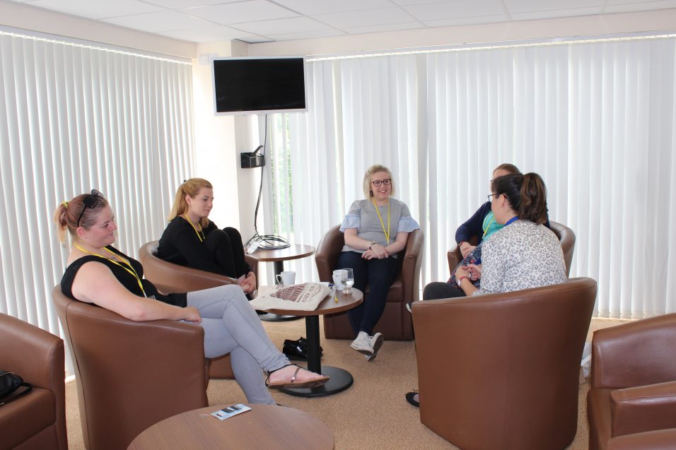 young women sat chatting together