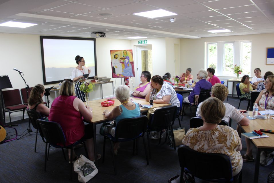 women sat at tables listening to Girls' Brigade speaker