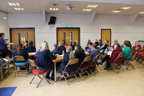 Girls' Brigade volunteers sat listening to training presentation