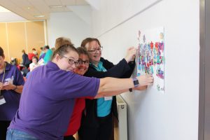 Girls' Brigade volunteers sticking jigsaw pieces to display