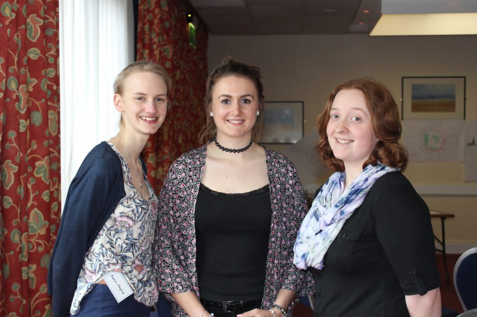 three young women smiling at camera