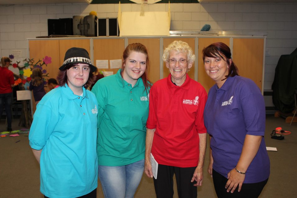 four Girls' Brigade volunteers at their group smiling at camera