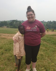 Girls' Brigade volunteer with Ugandan boy on FIZZ mission trip