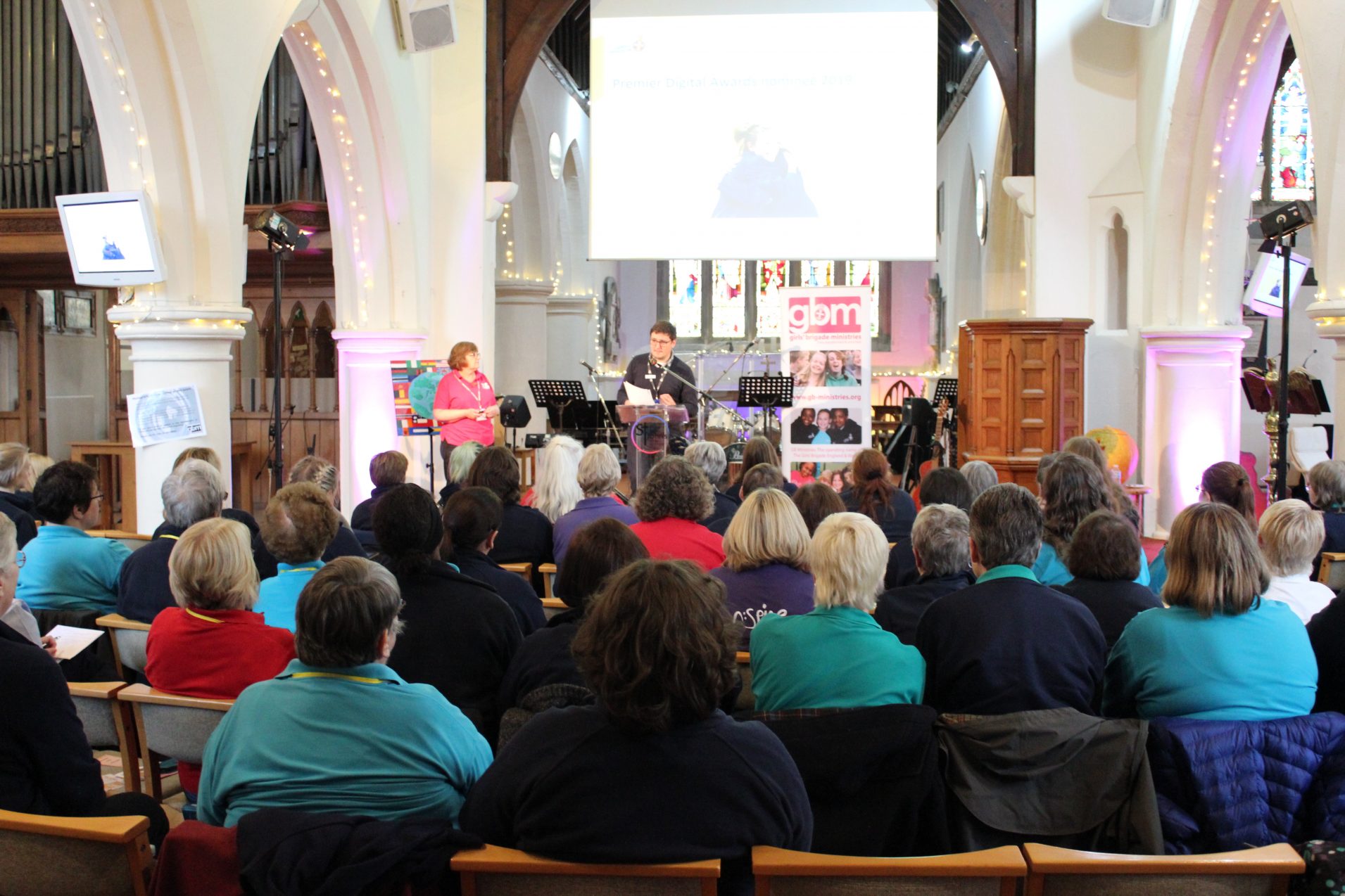 Girls' Brigade volunteers listening to speaker at conference