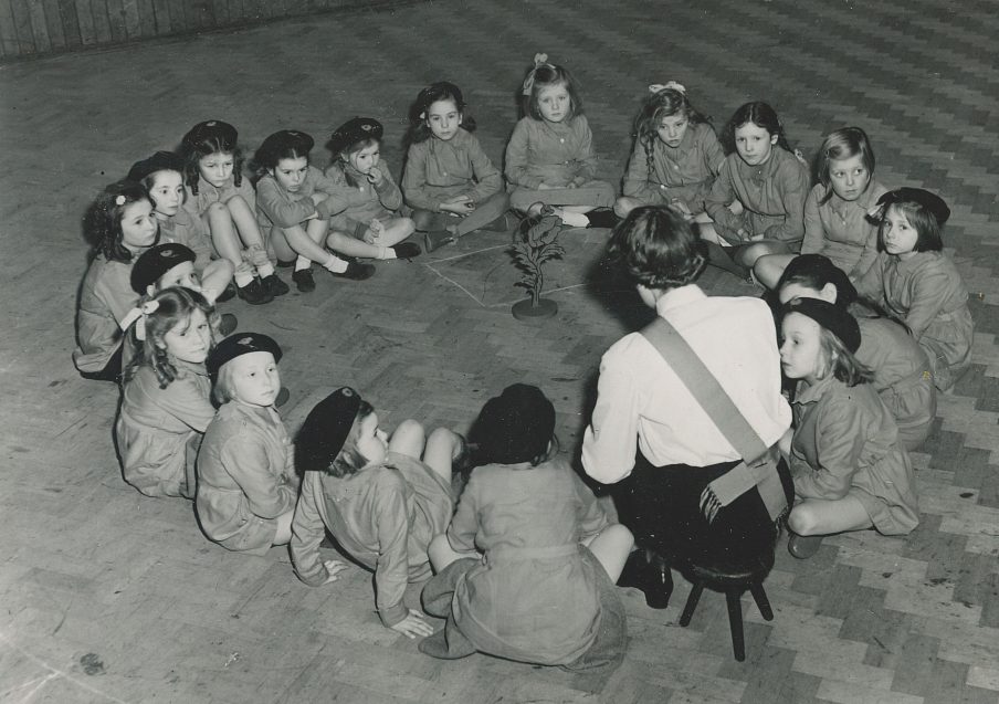 Girls' Guildry young girls sat in circle listening to leader teach