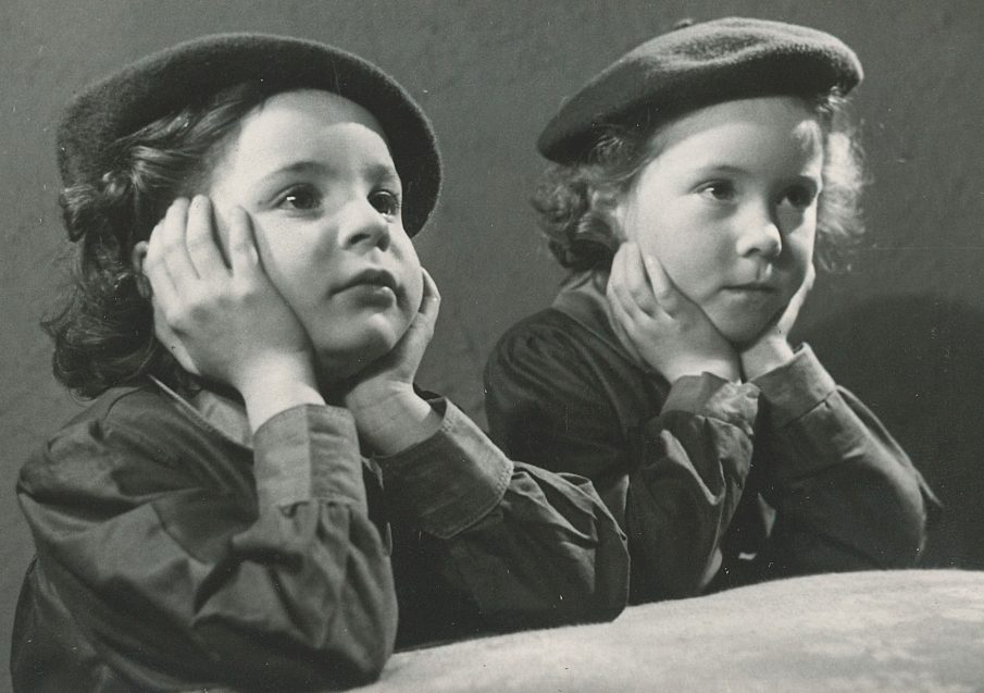 two young Girls' Guildry girls with chins in hands listening - black and white photo