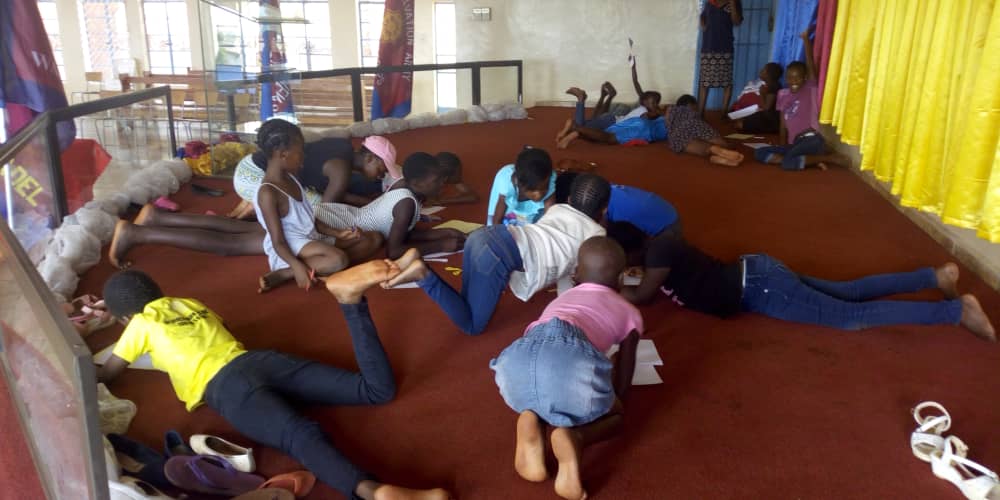 Girls' Brigade in Zimbabwe playing and learning on the floor