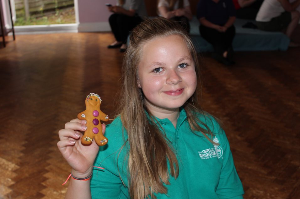 n:counta girl holding up gingerbread man