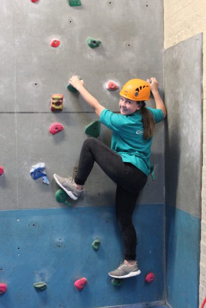 n:counta girl climbing on climbing wall