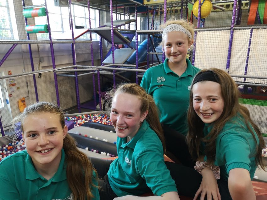 four n:counta girls smiling at camera in soft play area