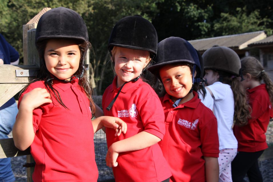 n:vestigate girls wearing horse riding helmets