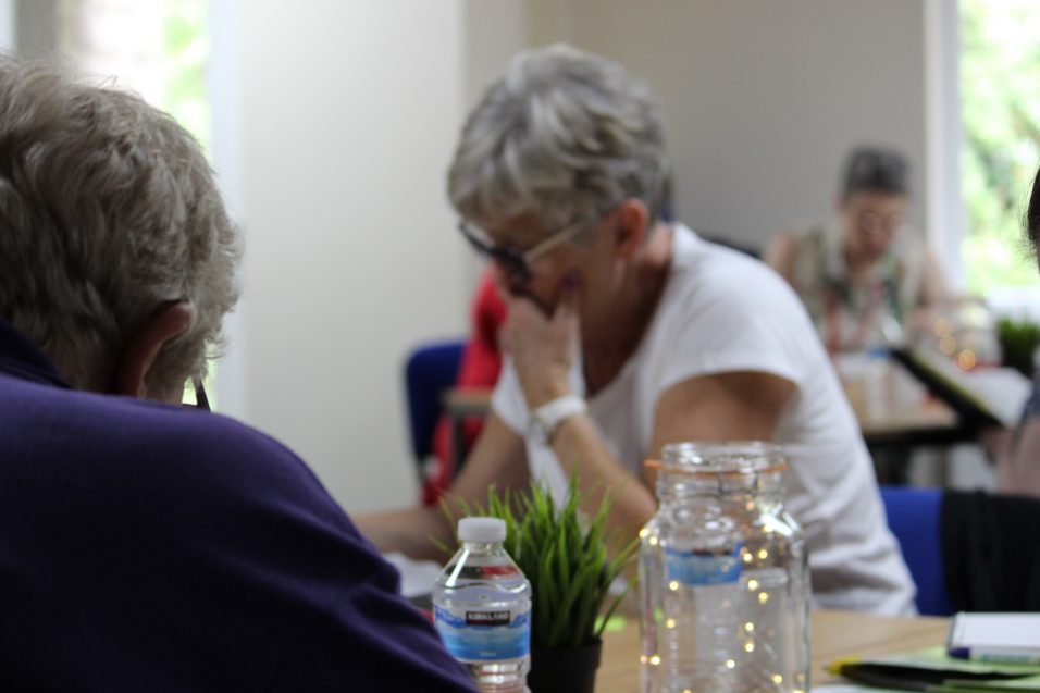 two women reading at a table during a retreat