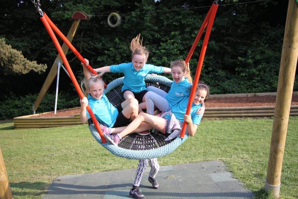 four n:gage girls in large park swing
