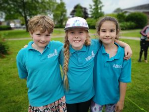 three n:gage girls with arm around each other at park