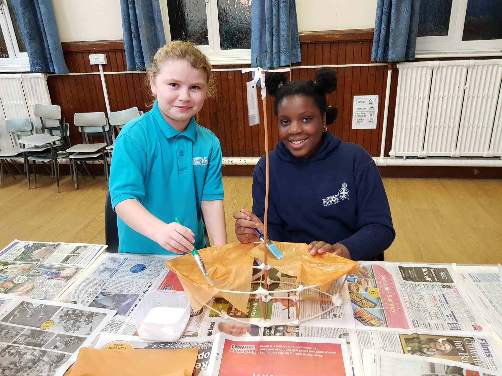 Young girls making a boat lantern craft