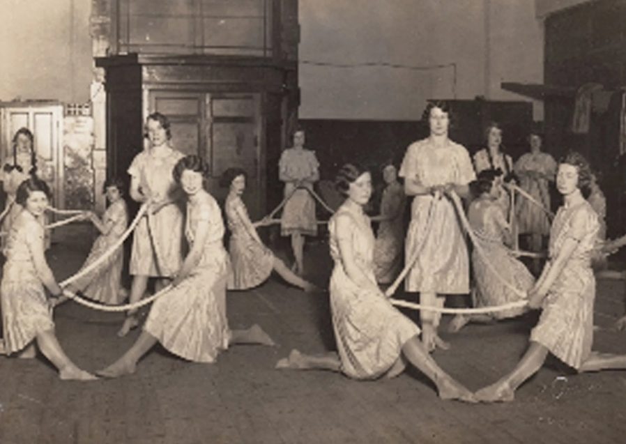 Girl's dancing with scarves in a gym hall - black and white