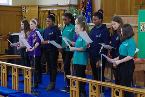 Teenage GB members singing in a church