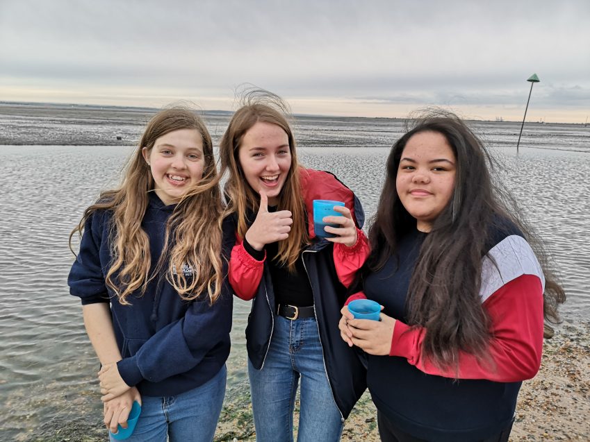 three teens on beach