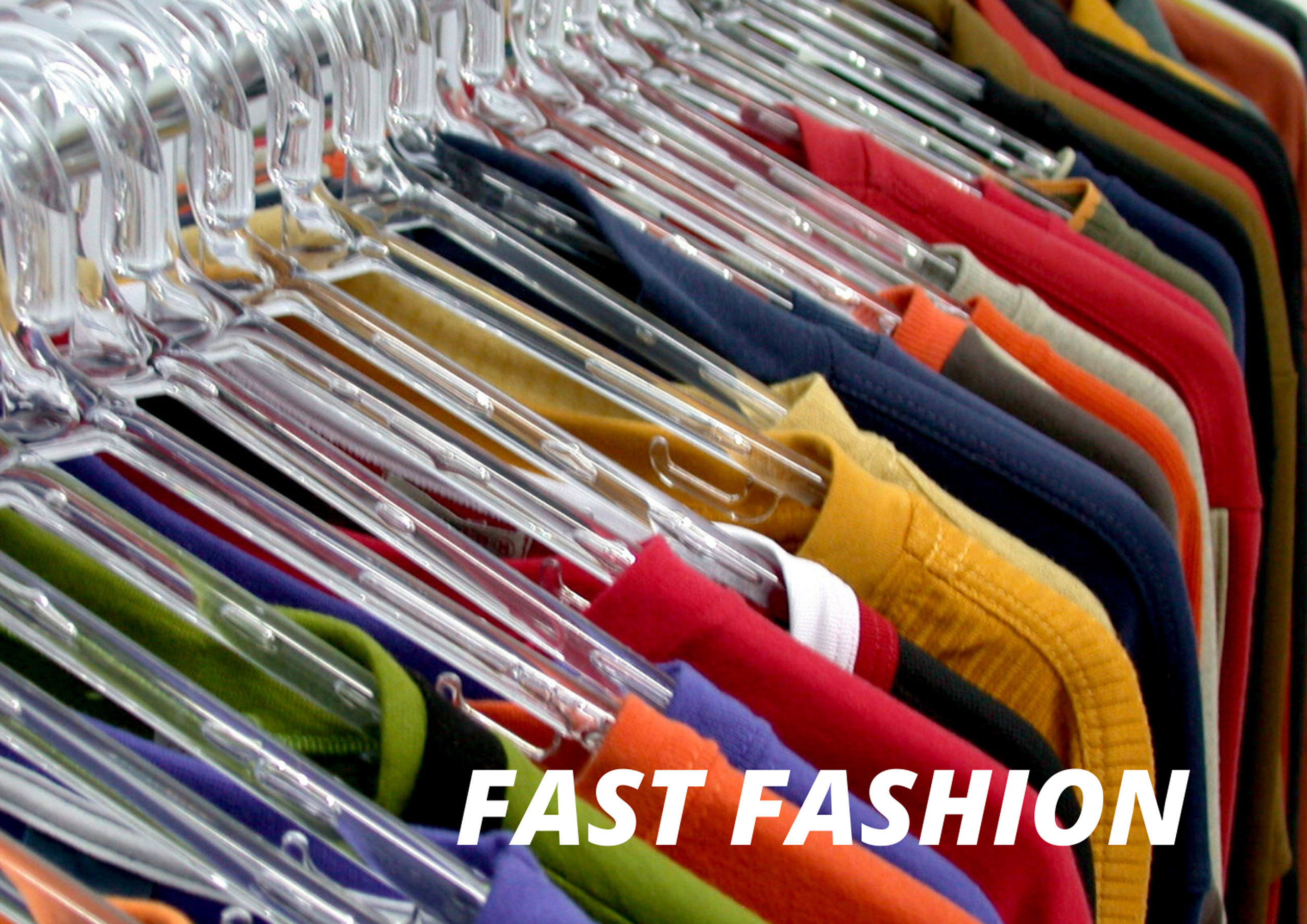 brightly coloured clothes on hangers on a clothes rack