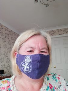 Dawn models a purple face mask with crest