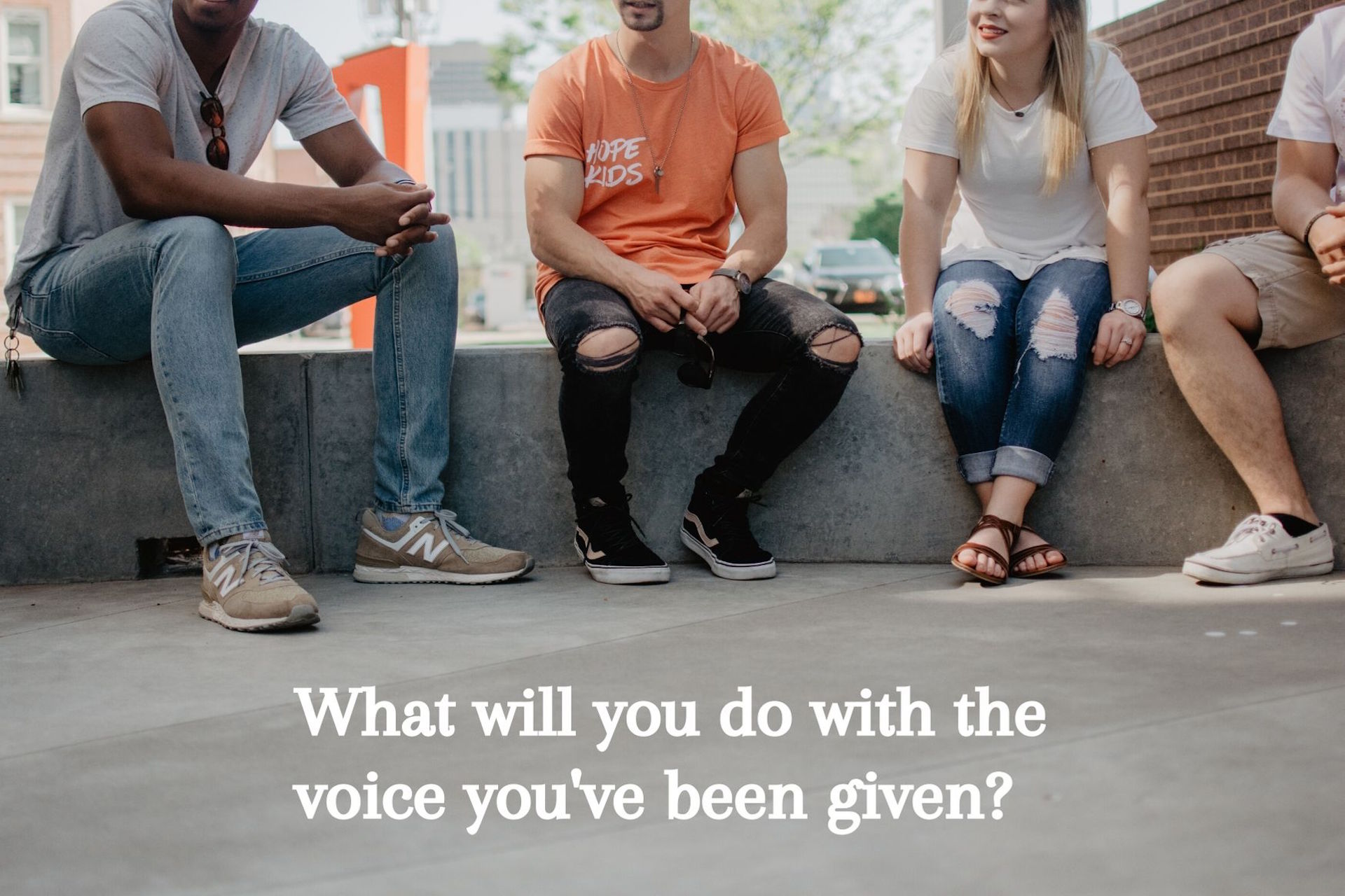 Four young adults sat around talking