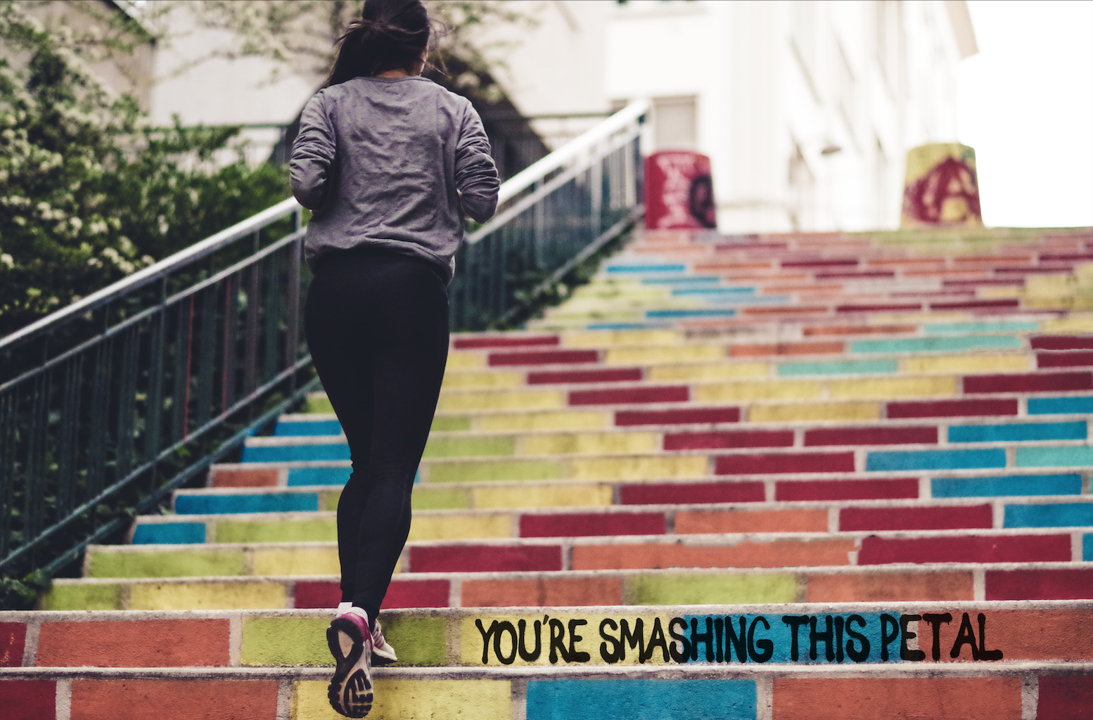 Woman running up colourful steps