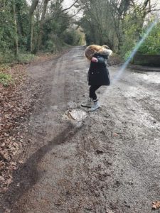 girl jumping into puddle