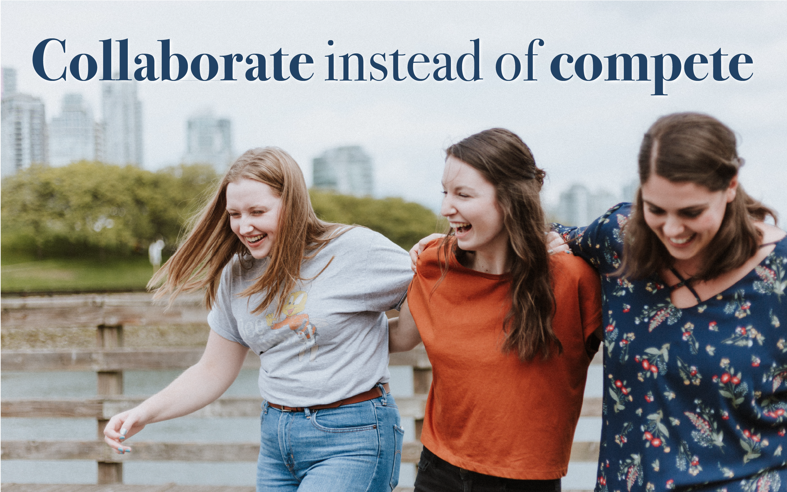 Three girls laughing with arms around each other