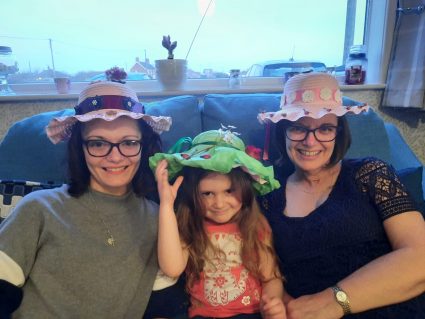 GB member and volunteers wearing Easter bonnets at home