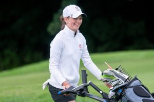 Photo of Emma Gourley with golf trolley