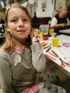 Girl showing a butterfly bracelet craft