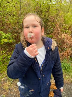 GB member blowing dandelion