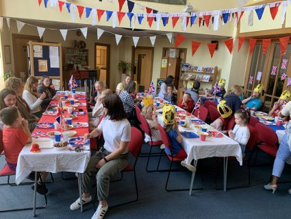 GB and church members enjoying tea party in church hall