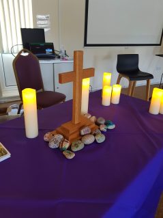 Cross and candles on table