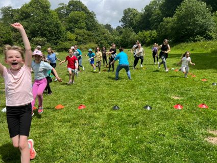 Young people running in church gardens