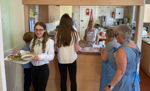 GB and church members serving from church kitchen