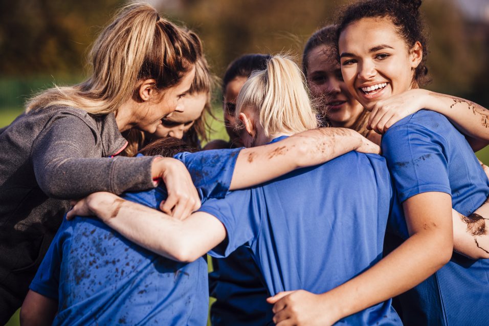 Female Rugby Players Together in a Huddle