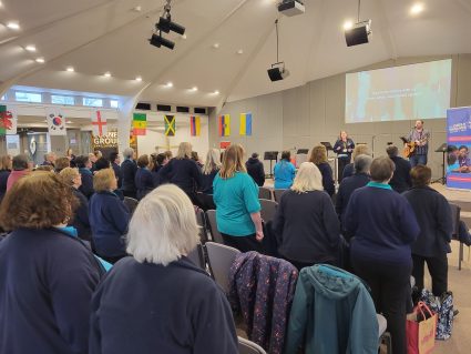 GB volunteers taking part in singing worship at conference