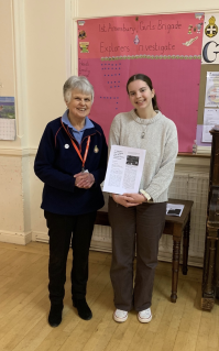 GB member holding piece of work next to Team Leader