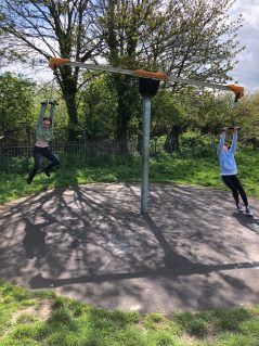 GB members playing on seesaw swing in park