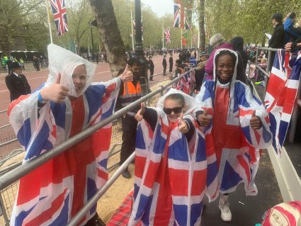 GB members wearing union jack ponchos gathered for King Charles coronation