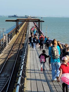 GB members walking on pier