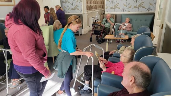 n:gage member handing card to care home resident