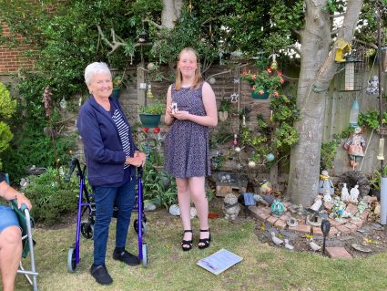 GB member receiving award from team leader in community garden