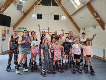 GB members and volunteers wearing bouncy shoes in church hall