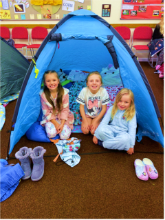 GB members sat outside tent in church hall