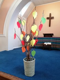 A memory tree containing coloured paper prayers