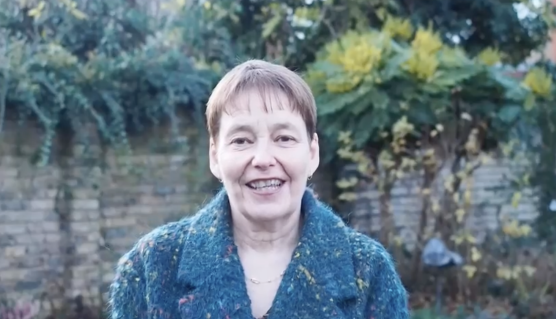 Screenshot of Christmas Message video. Jo Greengrass stood outside smiling at camera