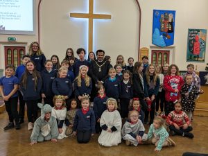 GB members in uniform and nativity costumes posing for a group photo with the mayor