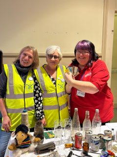 Jackie Hurst with WILE members behind table of collected litter